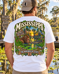 Mississippi Bigfoot shirt featuring Sasquatch face-to-face with an alligator in a cypress swamp with Spanish moss and The Magnolia State artwork.